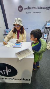 Kid waiting for his book to be signed