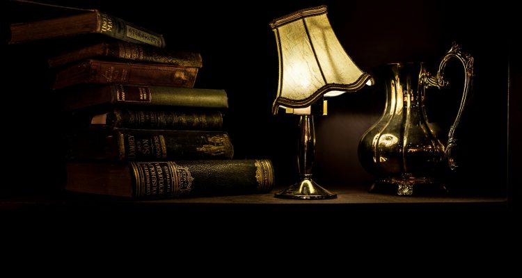 Books and lamp on a table